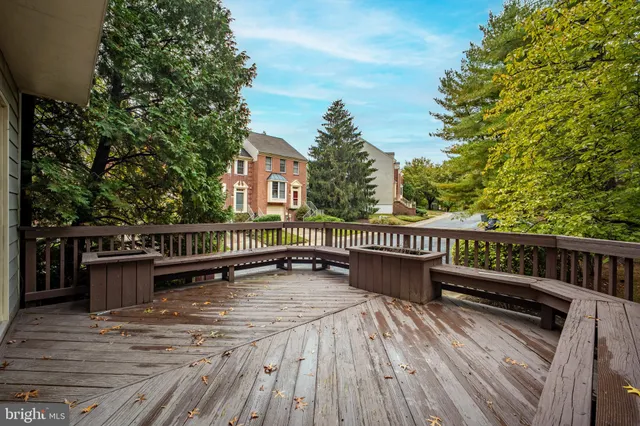 a view of a roof deck with wooden floor and fence