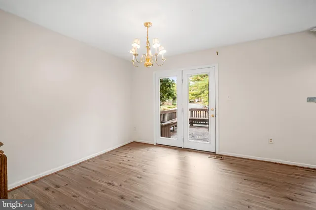 a view of wooden floor and chandelier in a room