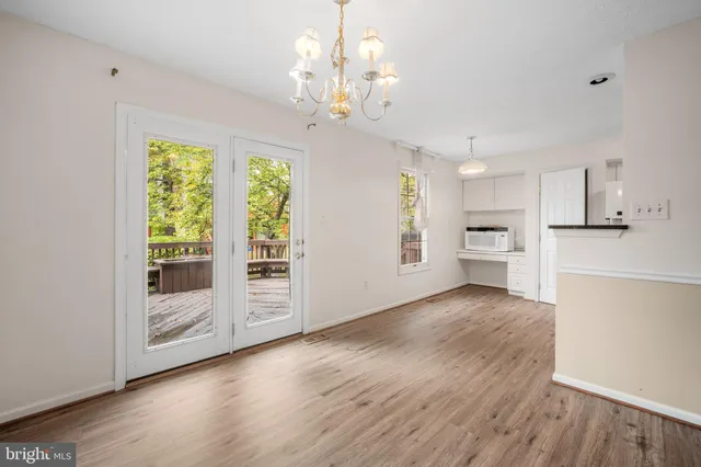a view of a kitchen with wooden floor and a large window
