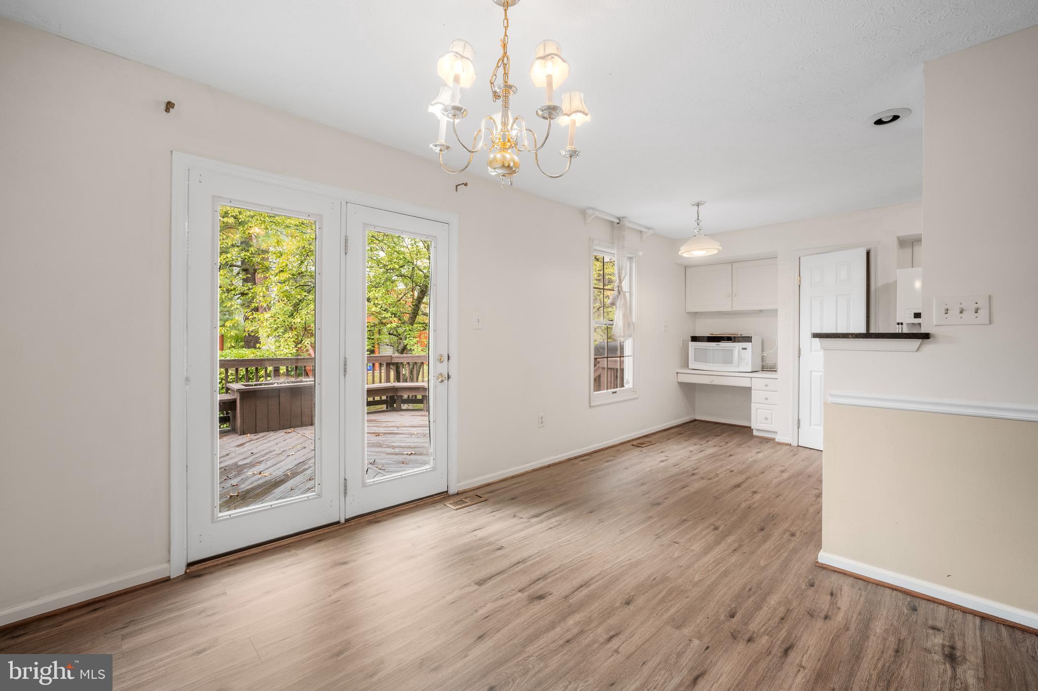 5522 April Journey, Unit 11 Columbia, MD 21044 - Photo 10 of 34 a view of a kitchen with wooden floor and a large window