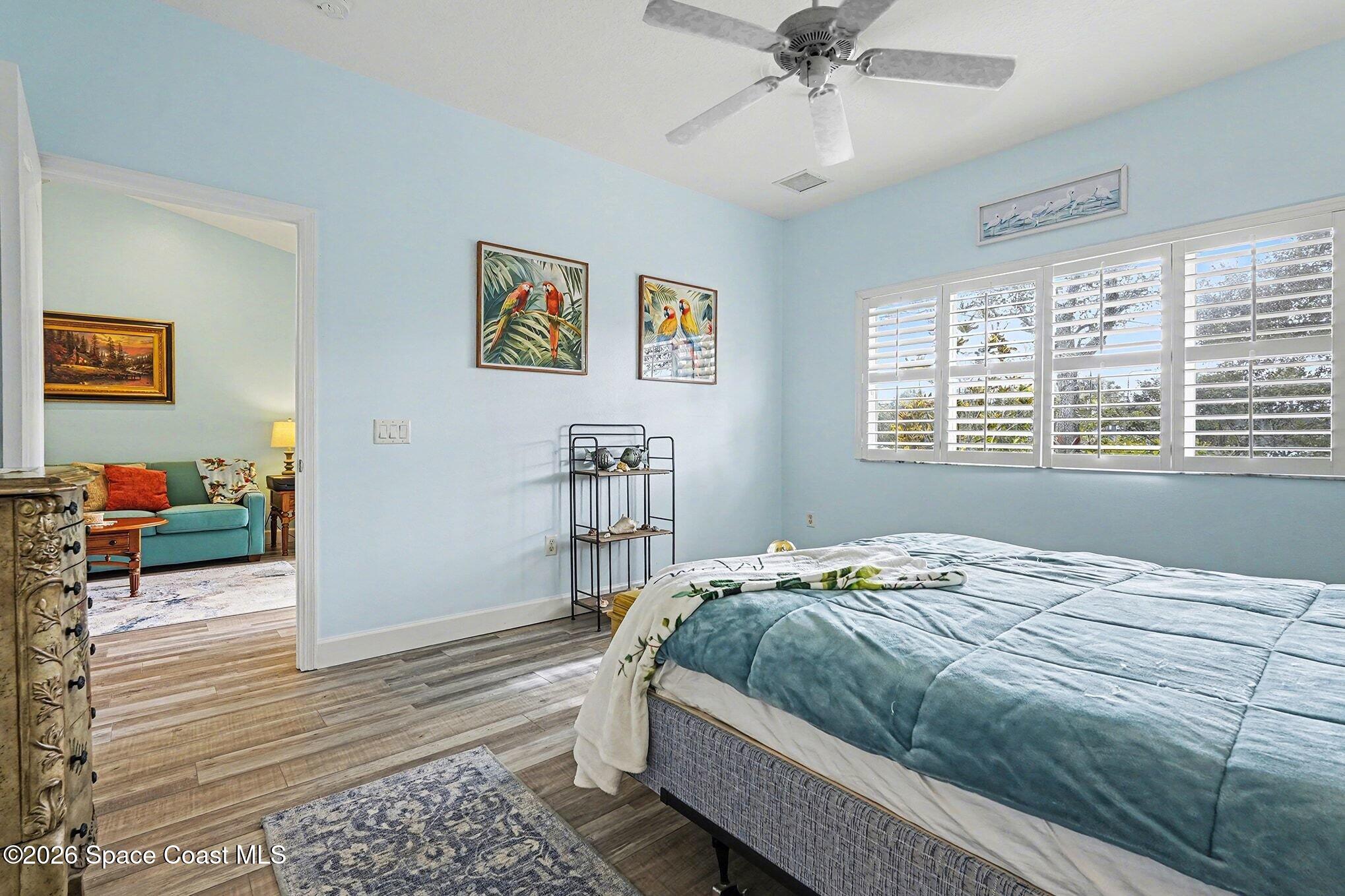 3051 Le Conte Street Melbourne, FL 32940 - Photo 13 of 32 a bedroom with a bed and a chandelier