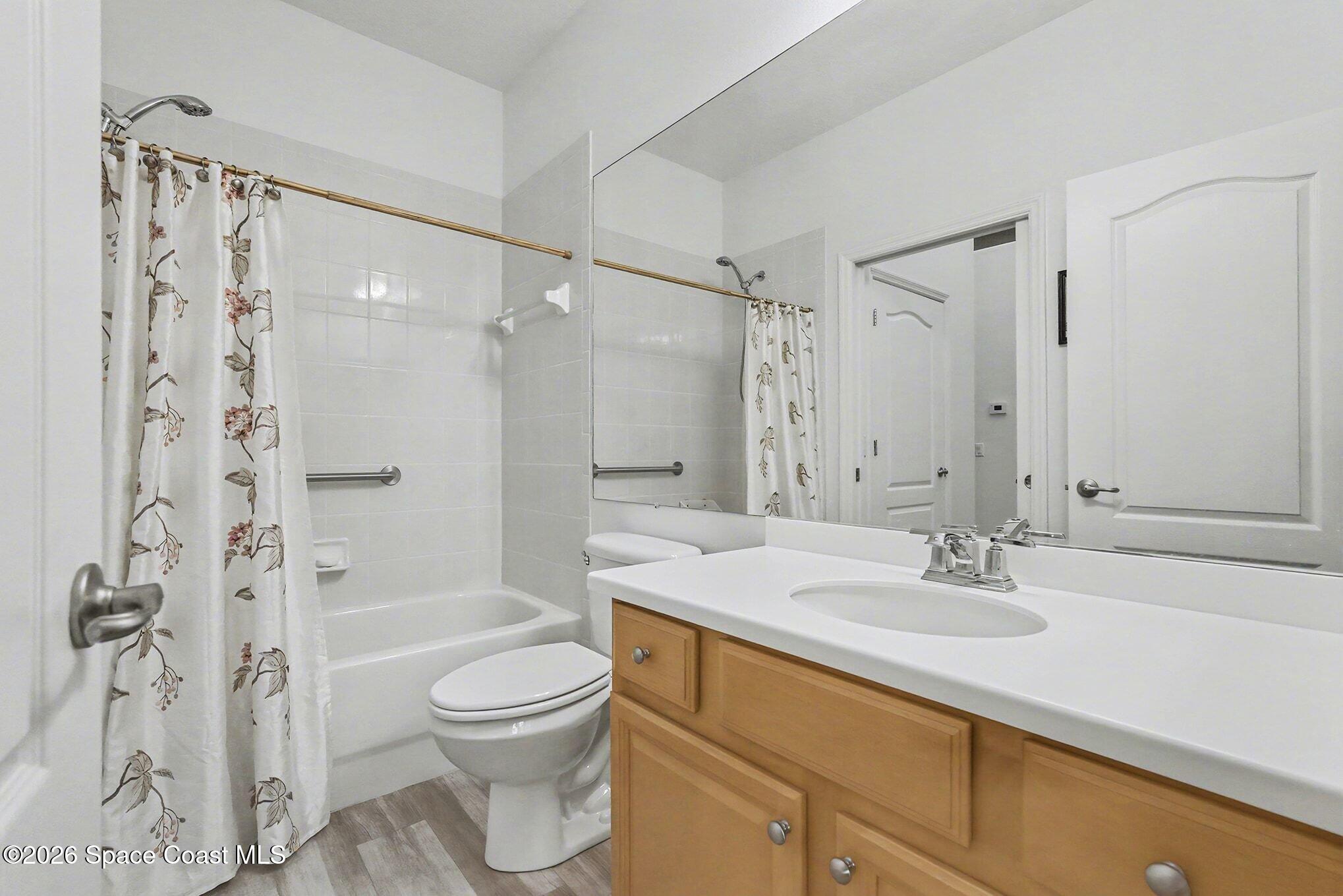 3051 Le Conte Street Melbourne, FL 32940 - Photo 17 of 32 a bathroom with a sink toilet a shower and a mirror