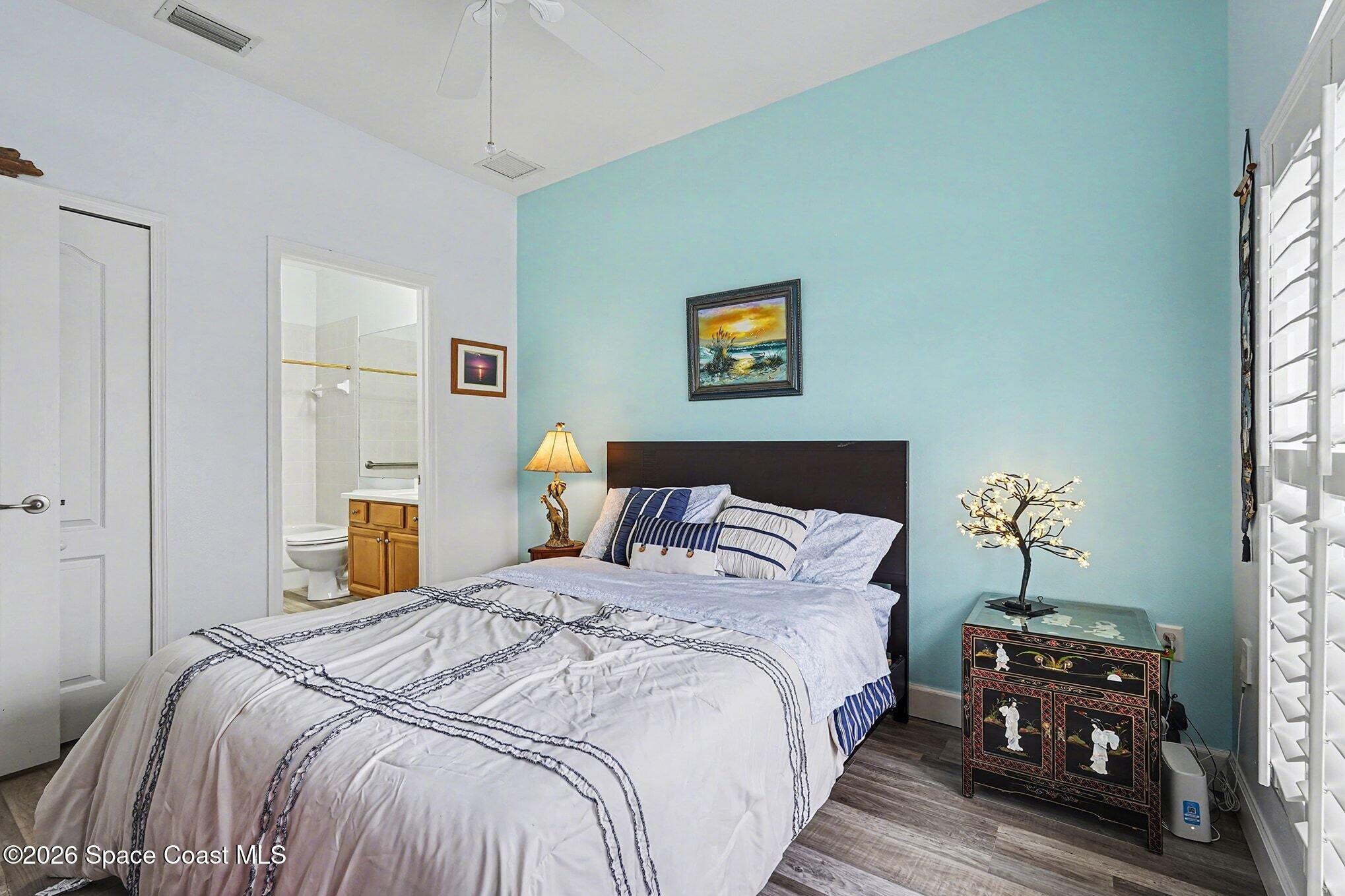 3051 Le Conte Street Melbourne, FL 32940 - Photo 19 of 32 a bedroom with bed and wooden floor