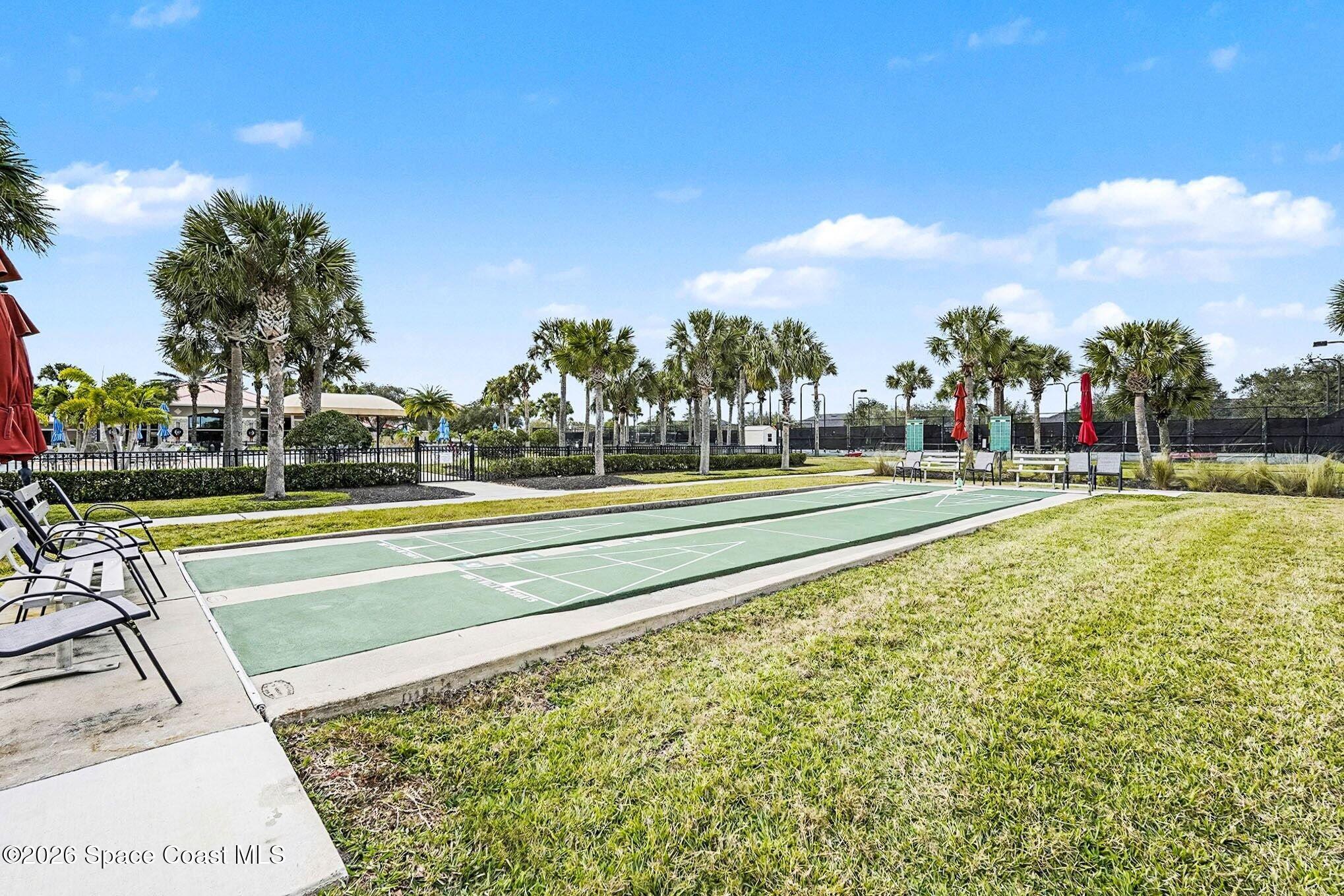 3051 Le Conte Street Melbourne, FL 32940 - Photo 27 of 32 a view of a swimming pool with a yard and palm trees