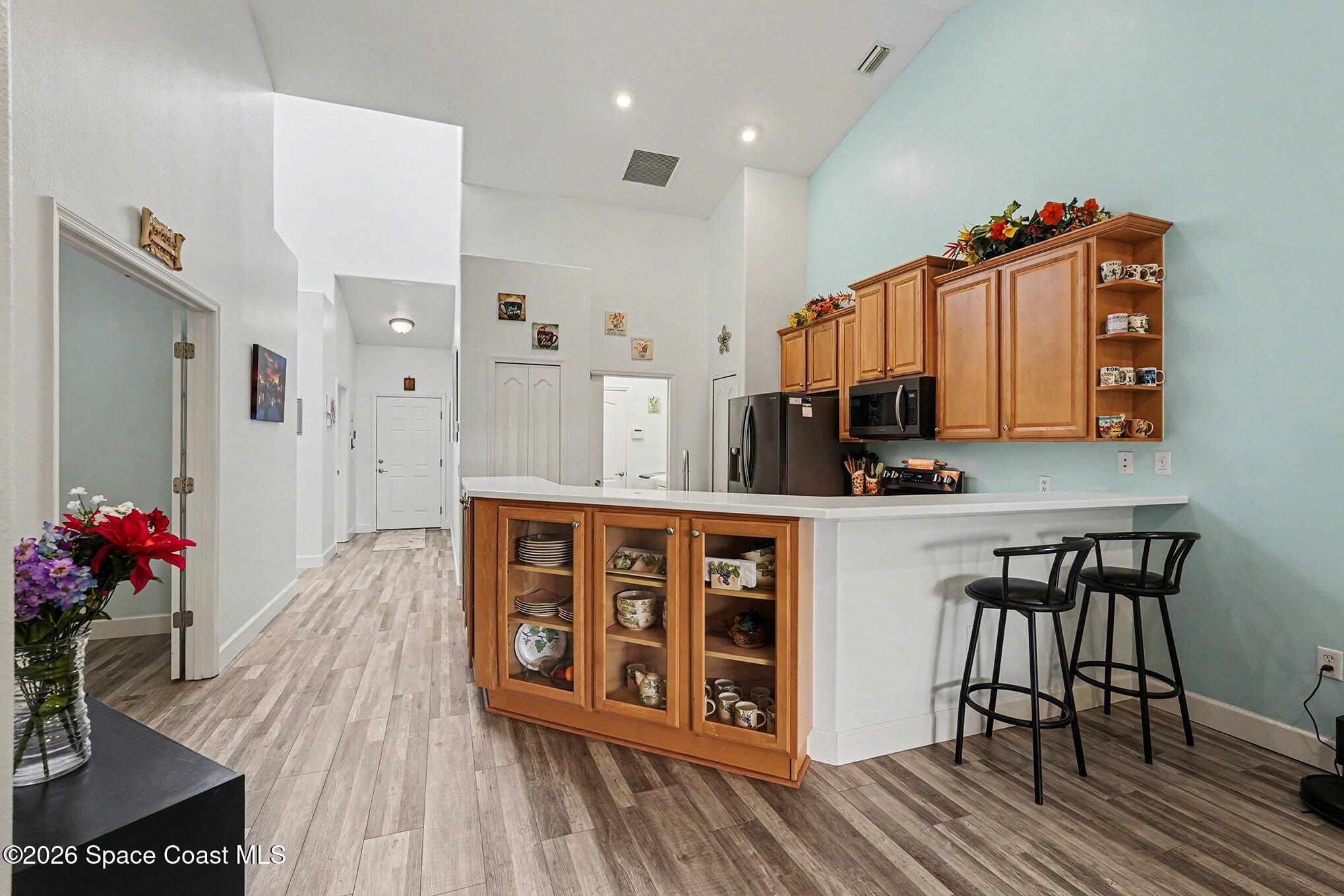 3051 Le Conte Street Melbourne, FL 32940 - Photo 5 of 32 a view of kitchen with cabinets and wooden floor