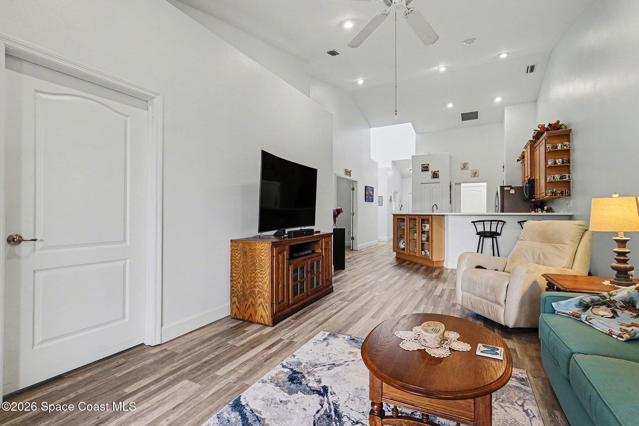 3051 Le Conte Street Melbourne, FL 32940 - Photo 8 of 32 a living room with furniture a rug and a flat screen tv