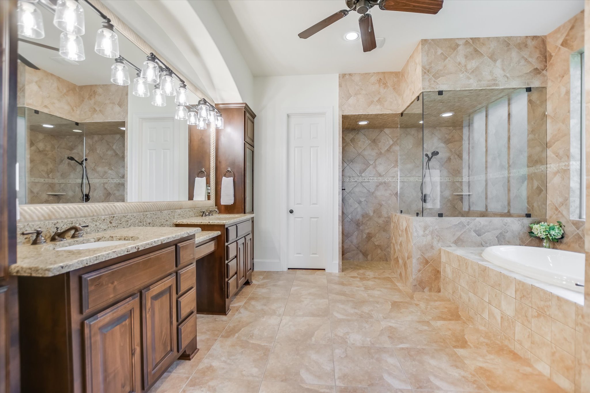 1016 SANTALUZ Path Austin, TX 78732 - Photo 13 of 40 Primary bathroom features dual vanities, a soaking tub, and a walk-in shower for spa-like relaxation