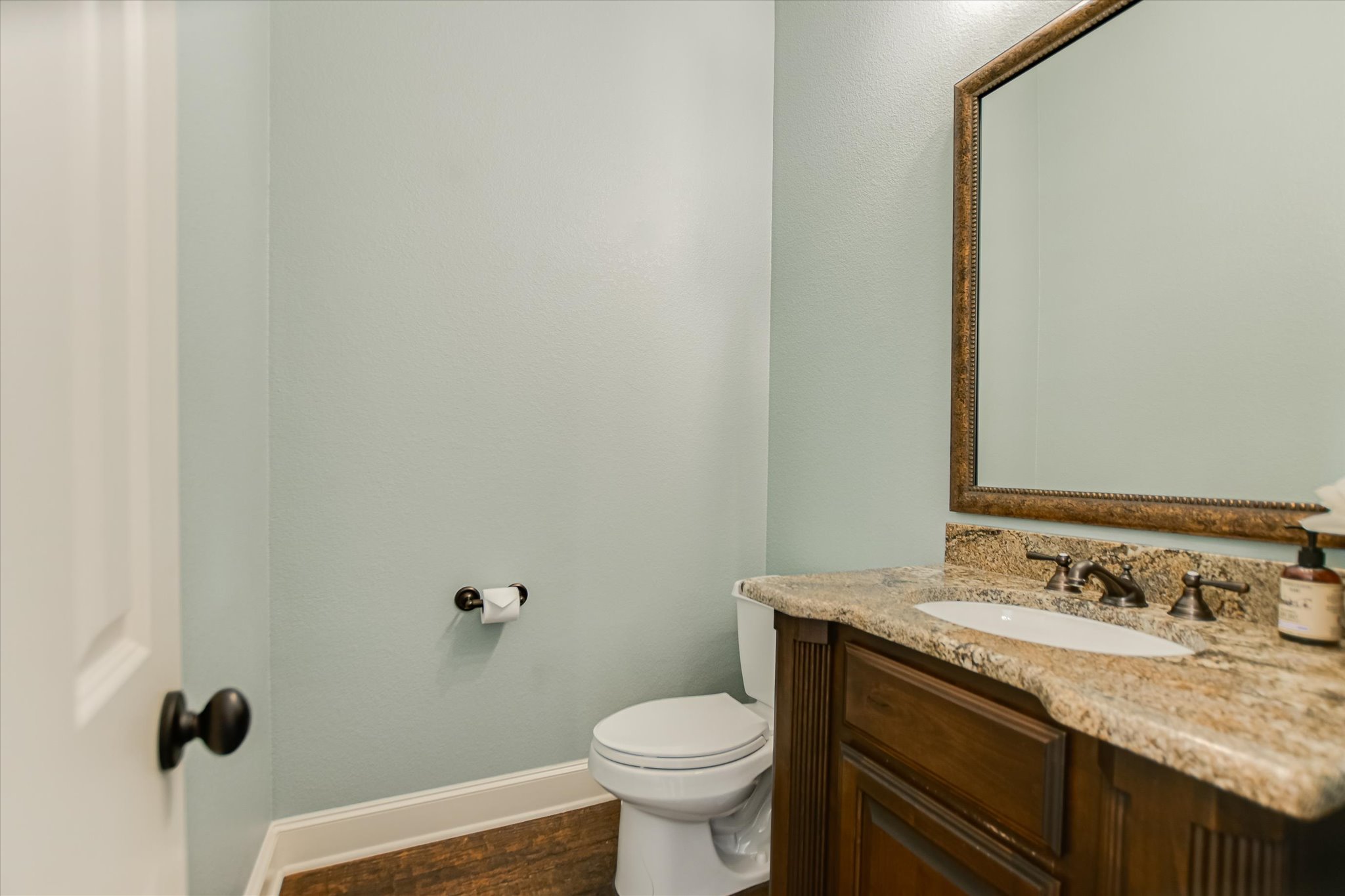 1016 SANTALUZ Path Austin, TX 78732 - Photo 19 of 40 Half-bath featuring vanity, toilet, baseboards, and wood finished floors