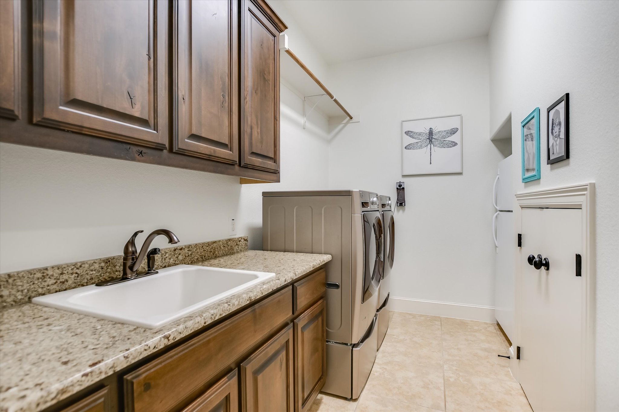 1016 SANTALUZ Path Austin, TX 78732 - Photo 30 of 40 Main level laundry room with sink, storage for laundry, and ample cabinet storage for laundry supplies