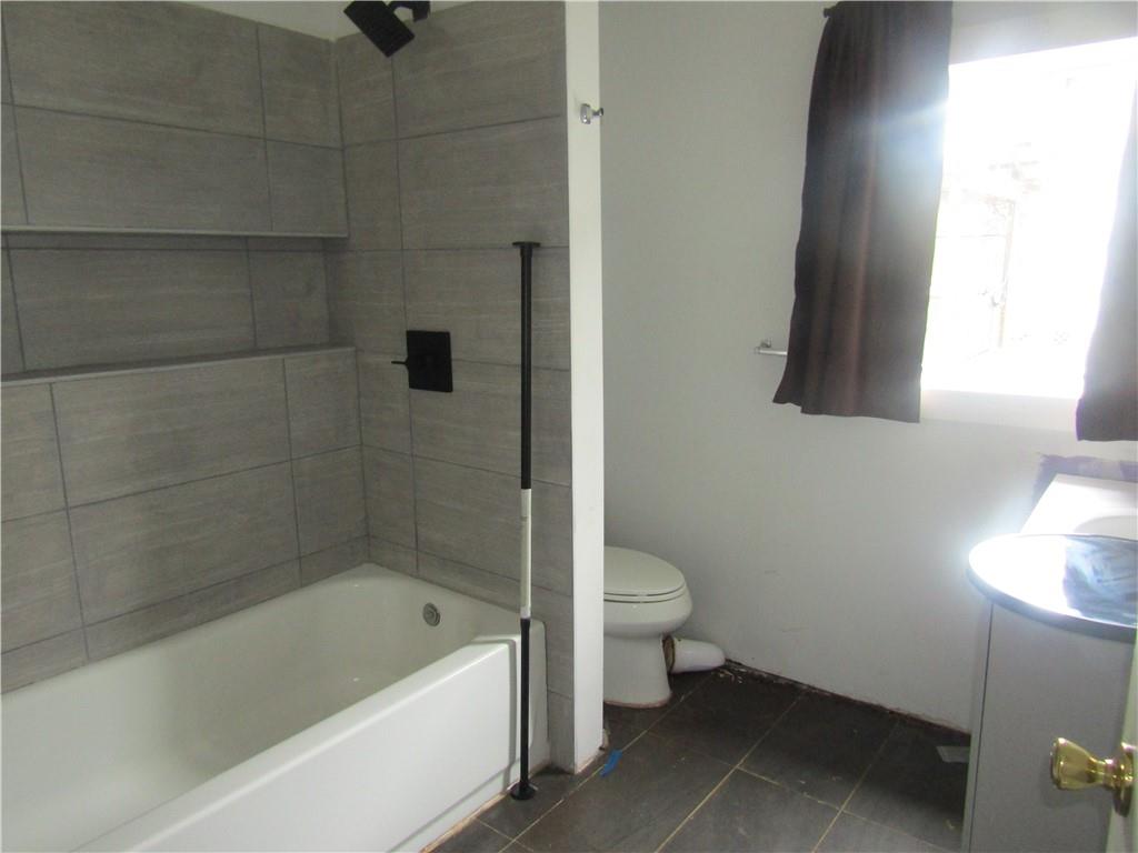 521 Williams Street Confluence, PA 15424 - Photo 31 of 38 a bath room with a toilet a bath tub and a shower