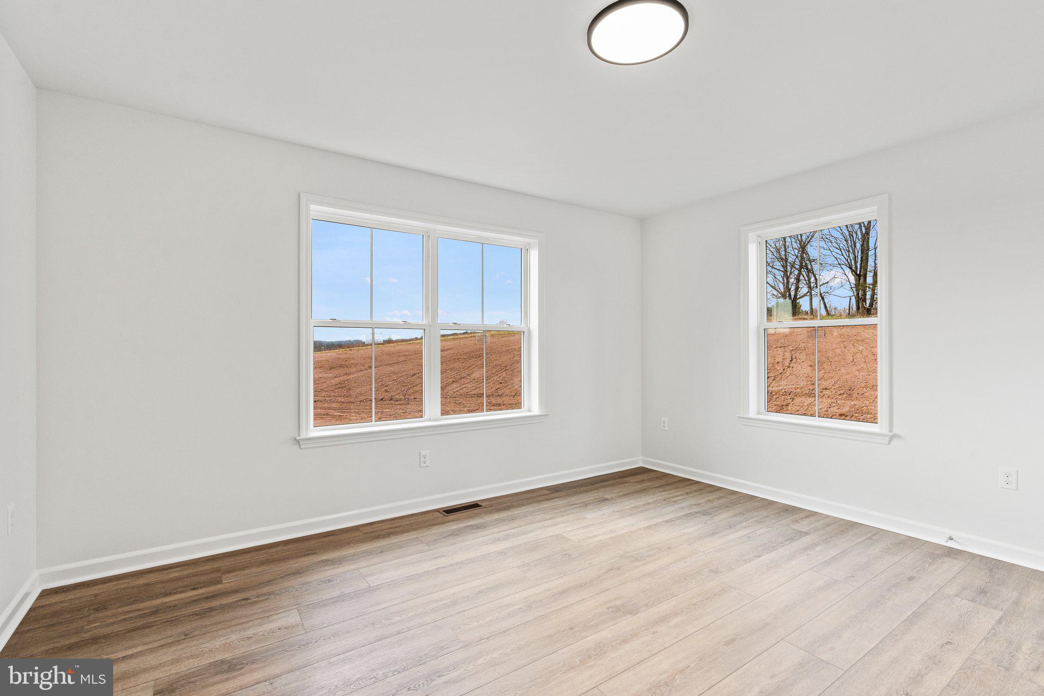 239 Brookview Drive Newport, PA 17074 - Photo 22 of 42 an empty room with wooden floor and windows