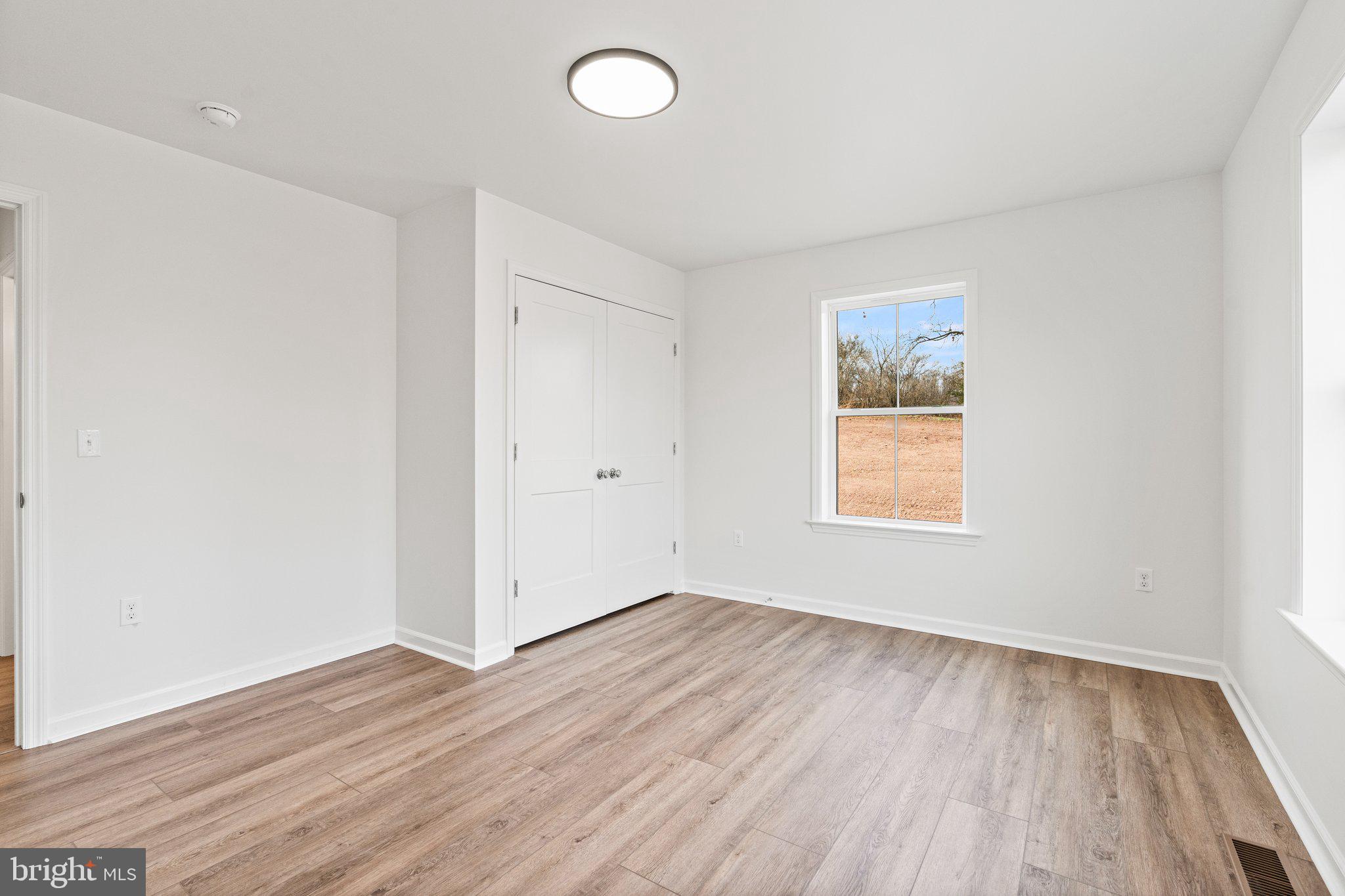 239 Brookview Drive Newport, PA 17074 - Photo 25 of 42 an empty room with wooden floor and windows