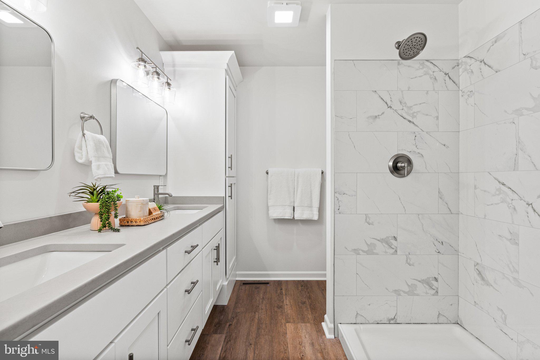 239 Brookview Drive Newport, PA 17074 - Photo 37 of 42 a bathroom with a granite countertop sink a mirror a vanity and shower