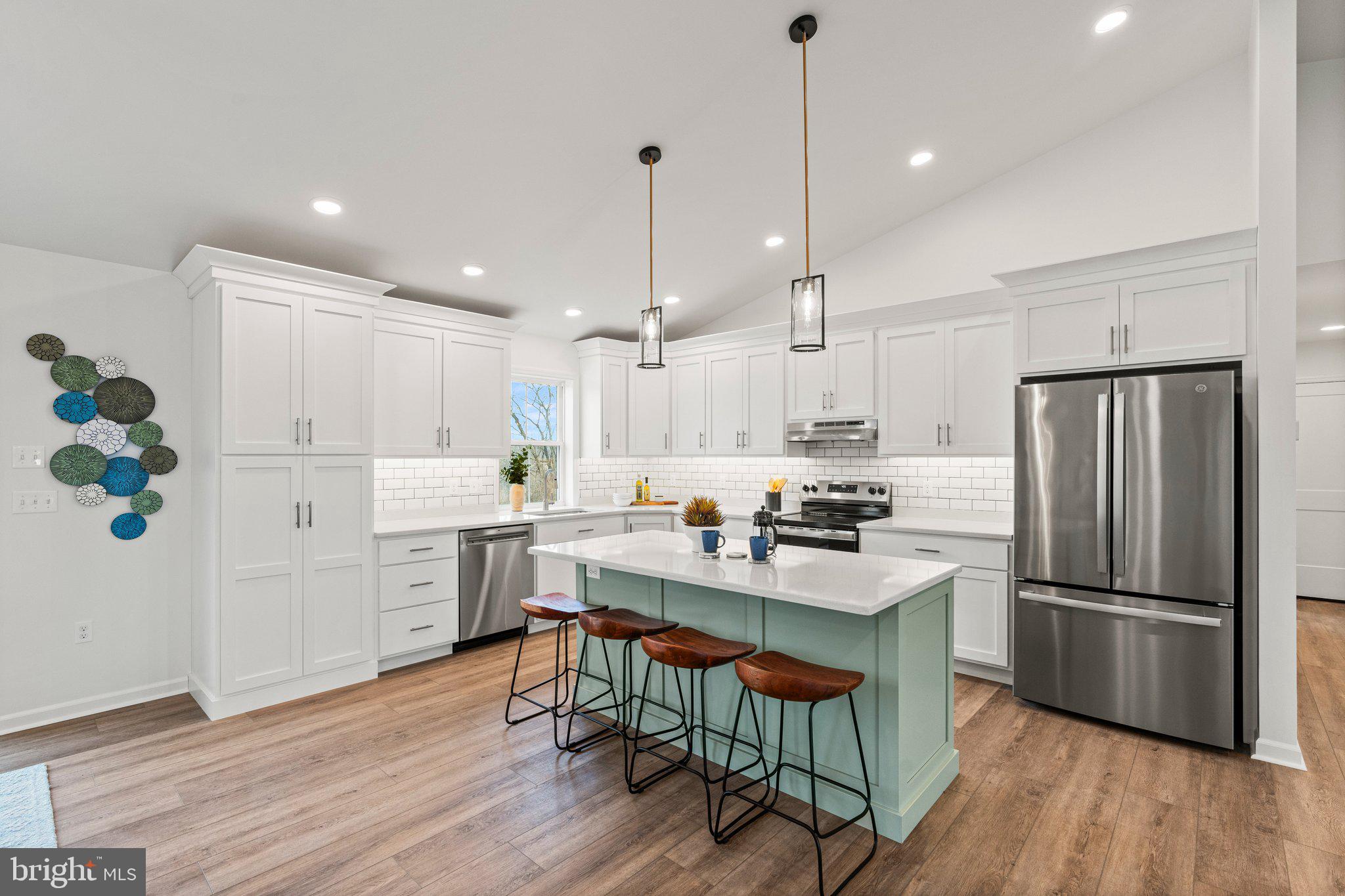 239 Brookview Drive Newport, PA 17074 - Photo 7 of 42 a kitchen with stainless steel appliances a refrigerator a sink dishwasher a stove a dining table and chairs with wooden floor