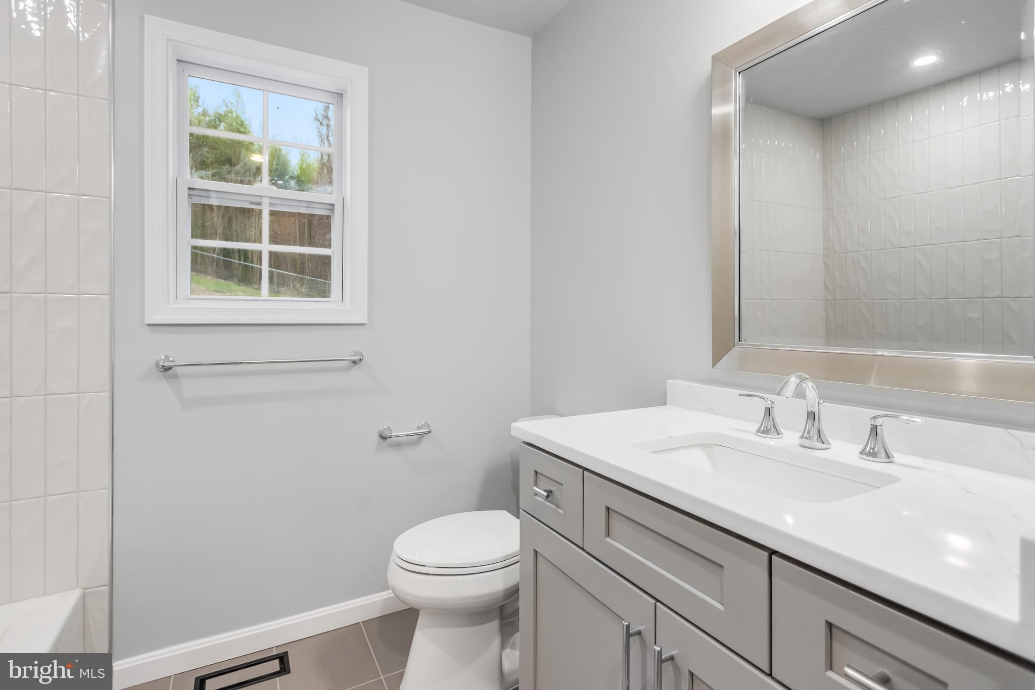 4010 Oaklawn Road Fort Washington, MD 20744 - Photo 19 of 37 a bathroom with a sink a toilet and a window