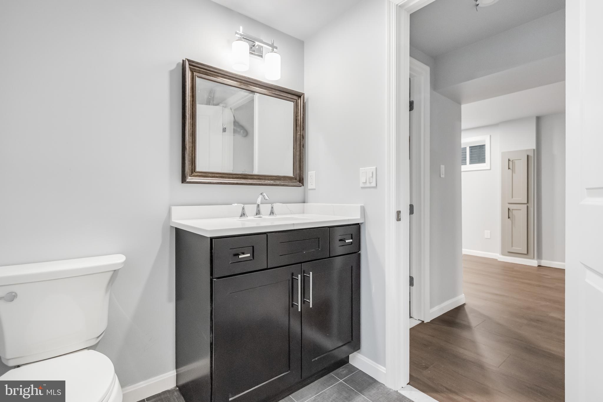 4010 Oaklawn Road Fort Washington, MD 20744 - Photo 26 of 37 a bathroom with a sink vanity and a toilet