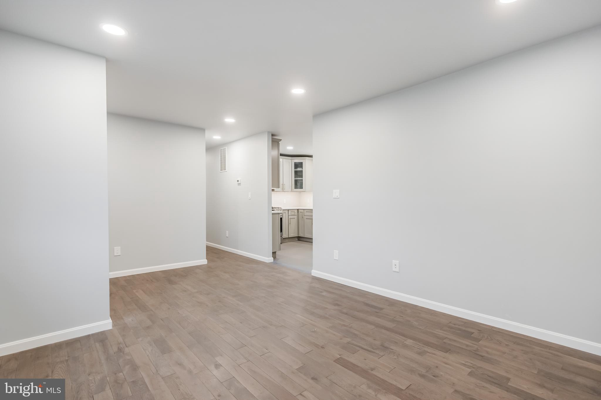 4010 Oaklawn Road Fort Washington, MD 20744 - Photo 36 of 37 a view of an empty room with wooden floor and a kitchen