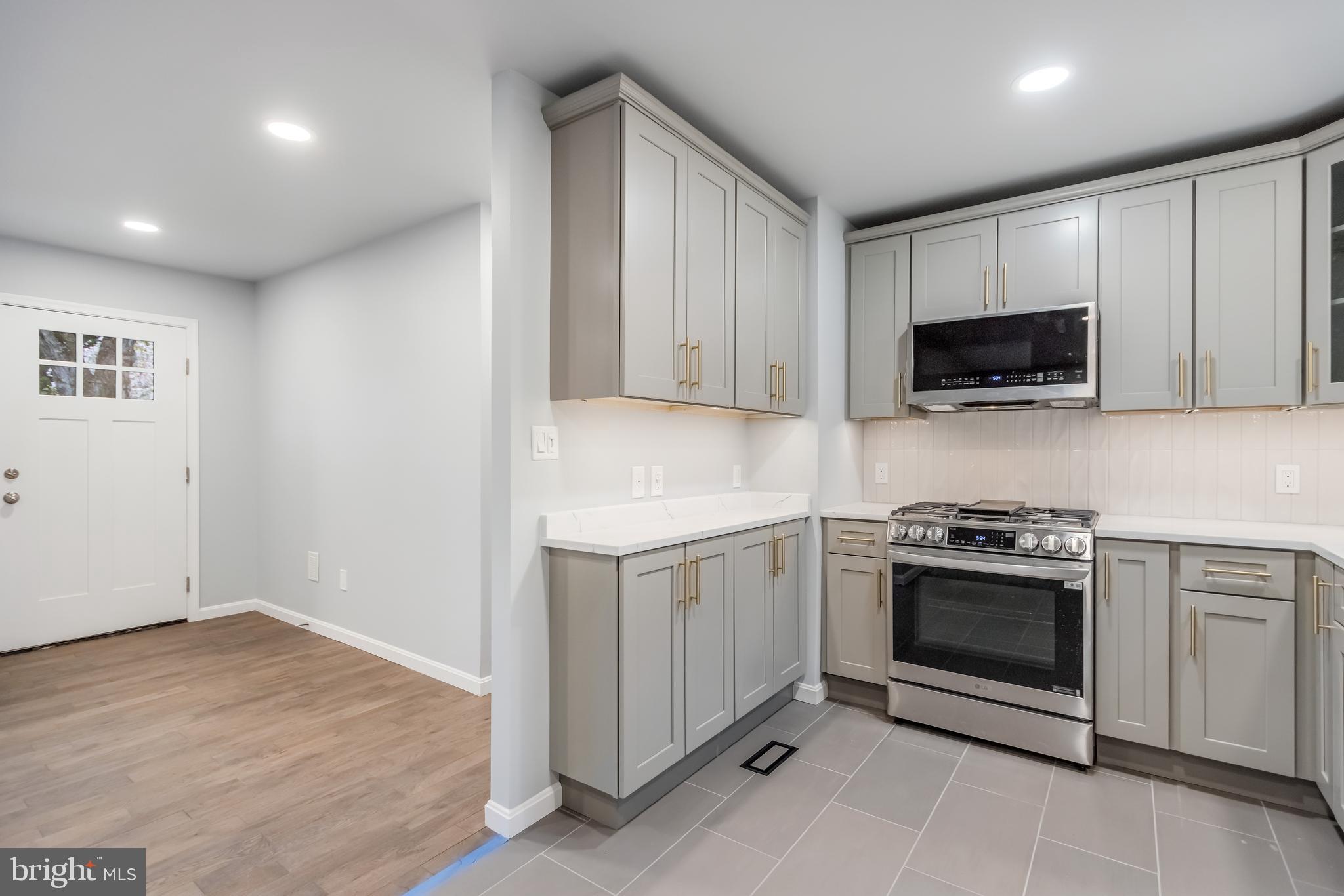 4010 Oaklawn Road Fort Washington, MD 20744 - Photo 10 of 37 a kitchen with granite countertop white cabinets and stainless steel appliances