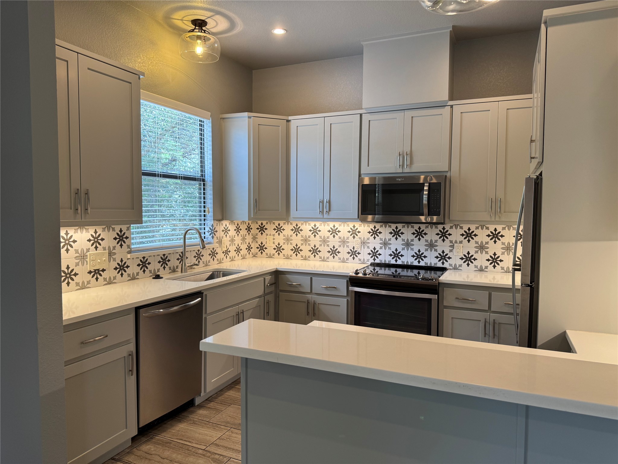 290 Hugo Road, Unit B San Marcos, TX 78666 - Photo 9 of 22 a kitchen with a sink stove and refrigerator