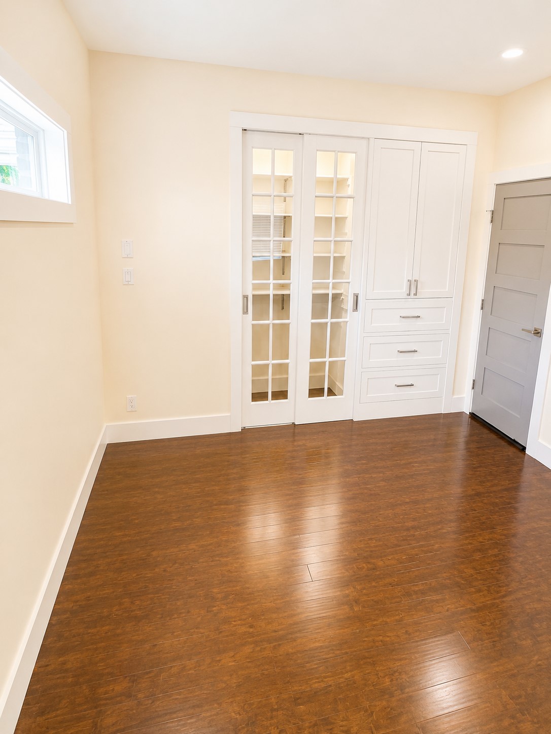2302 Ruth Street Houston, TX 77004 - Photo 10 of 18 The 1st floor secondary bedroom with glass front sliding doors & built-in storage.