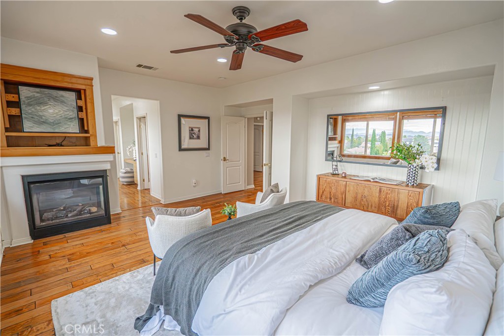28419 Hidden Hills Drive Saugus, CA 91390 - Photo 35 of 60 a bedroom with a bed and a fireplace