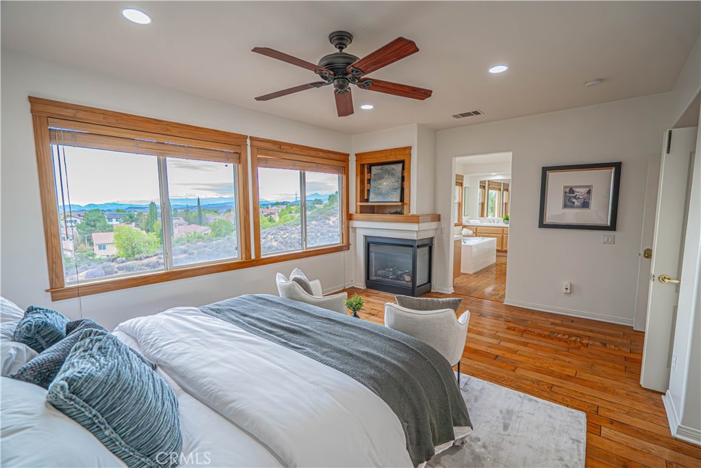 28419 Hidden Hills Drive Saugus, CA 91390 - Photo 36 of 60 a bedroom with a bed and a fireplace