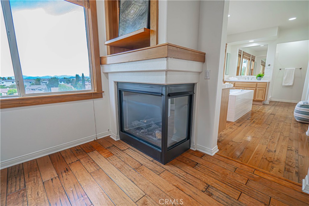28419 Hidden Hills Drive Saugus, CA 91390 - Photo 37 of 60 a view of a livingroom with wooden floor and a fireplace