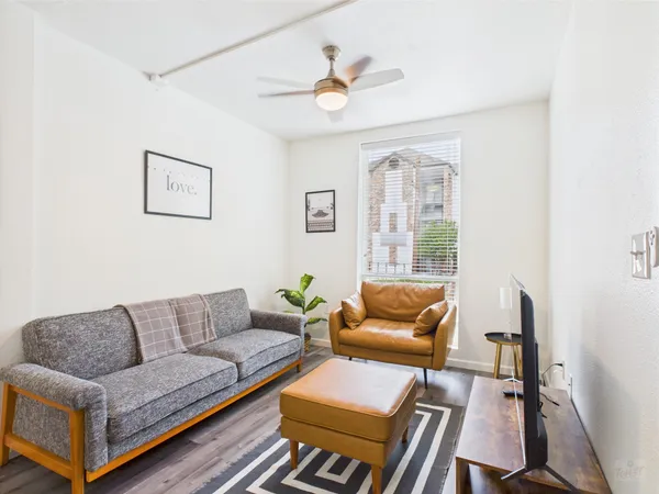a living room with furniture and a large window
