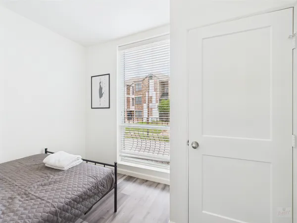 a bathroom with a granite countertop sink and a window