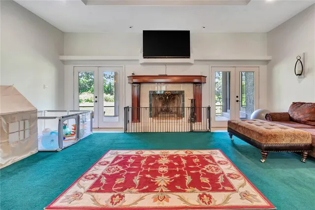 a living room with fireplace furniture and a flat screen tv