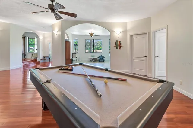 a room with pool table and windows