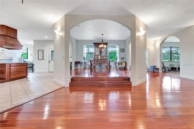 a view of a living room and kitchen with furniture wooden floor