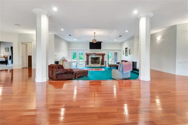 a living room with furniture wooden floor and a fireplace