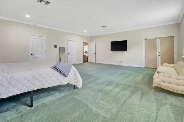 a bedroom with a bed and a couch