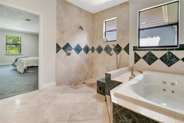 a bathroom with a bathtub and a shower