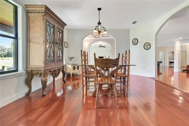 a view of a dining room with furniture and wooden floor