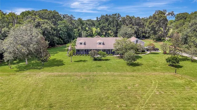 a view of a big yard with large trees