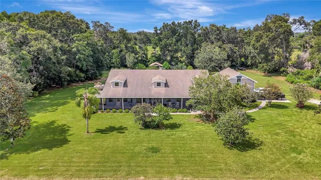 an aerial view of a house with a yard