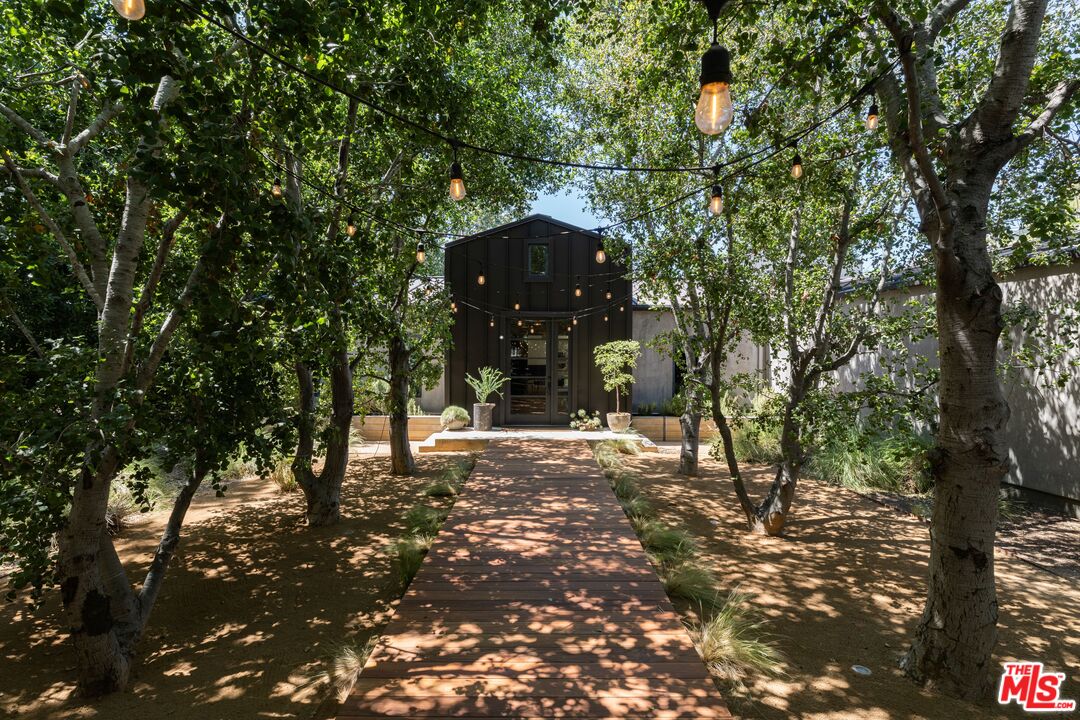 a view of a large tree in front of a yard