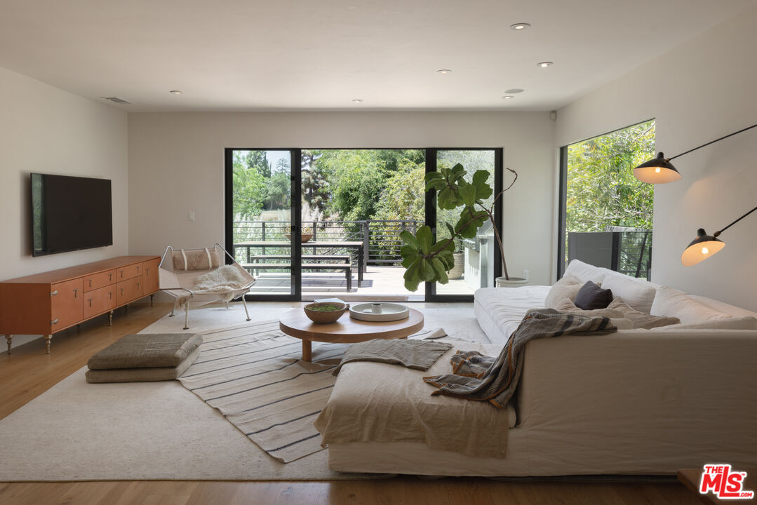 226 South Rimpau Boulevard Los Angeles, CA 90004 - Photo 17 of 43 a living room with furniture and a flat screen tv