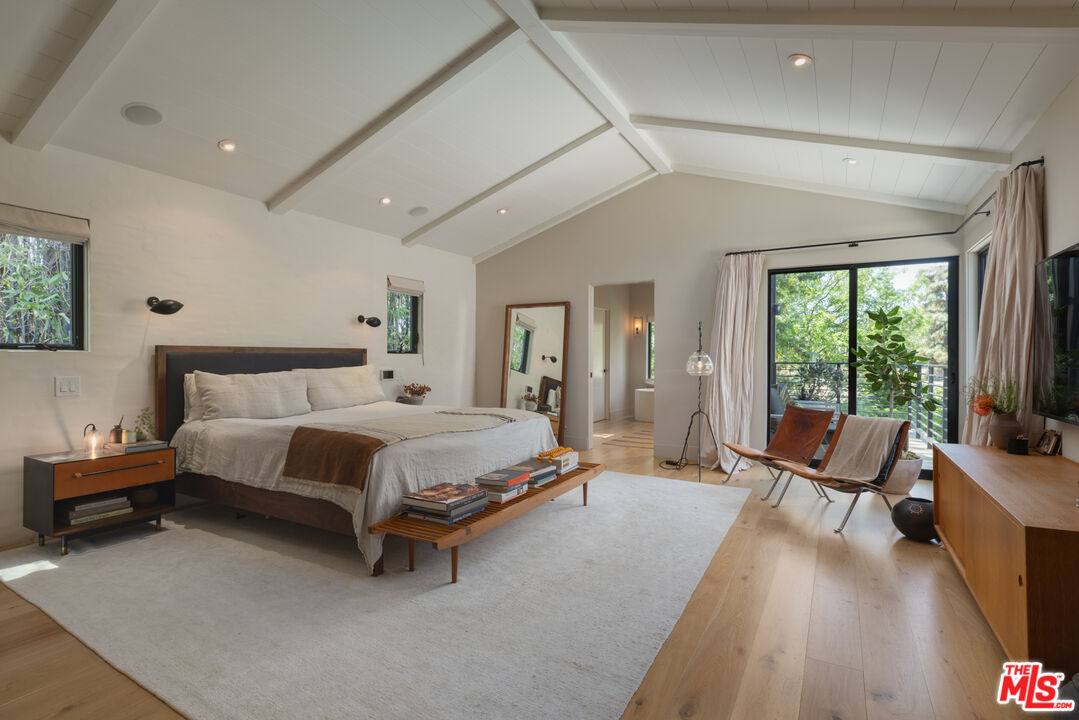 226 South Rimpau Boulevard Los Angeles, CA 90004 - Photo 19 of 43 a spacious bedroom with a bed and large windows