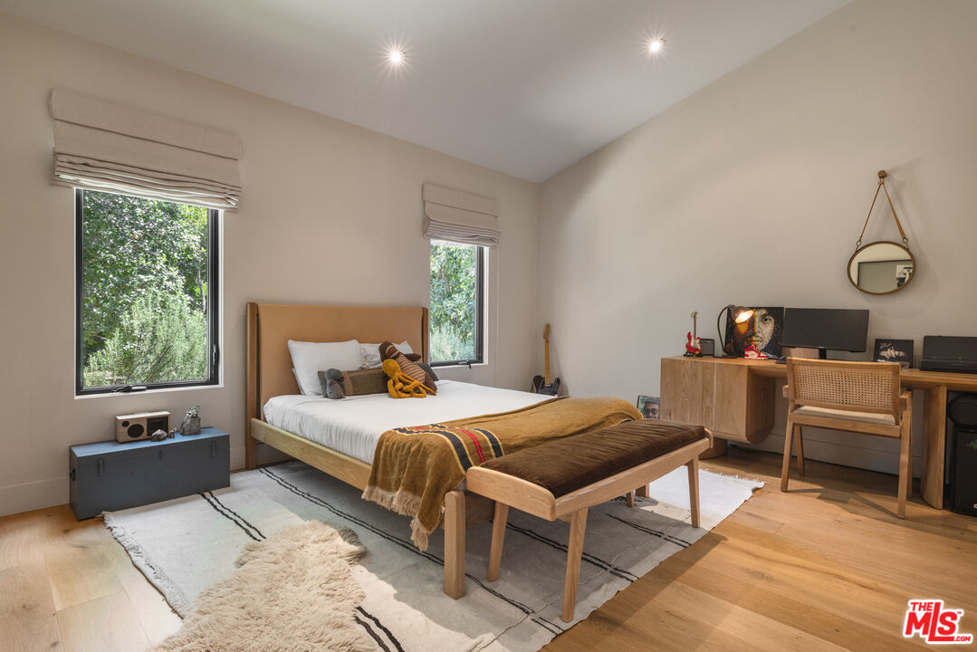 226 South Rimpau Boulevard Los Angeles, CA 90004 - Photo 22 of 43 a bedroom with a bed and wooden floor