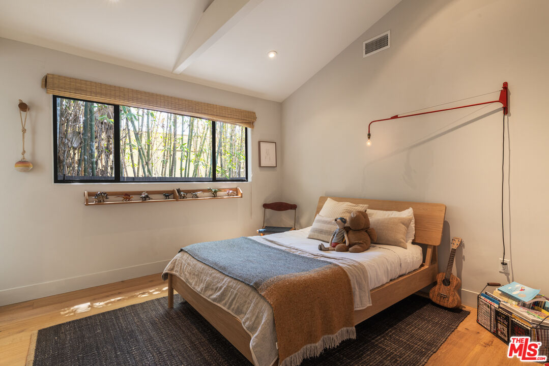 226 South Rimpau Boulevard Los Angeles, CA 90004 - Photo 24 of 43 a bedroom with a bed and window