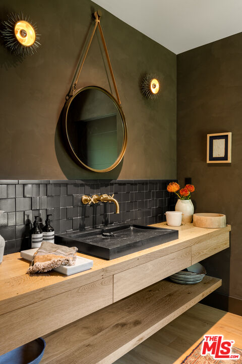 226 South Rimpau Boulevard Los Angeles, CA 90004 - Photo 32 of 43 a bathroom with a sink and a mirror