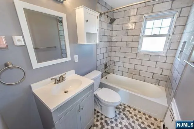 a bathroom with a sink toilet a mirror and shower