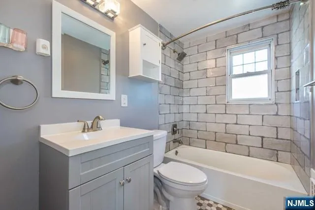 a bathroom with a sink toilet a mirror and shower