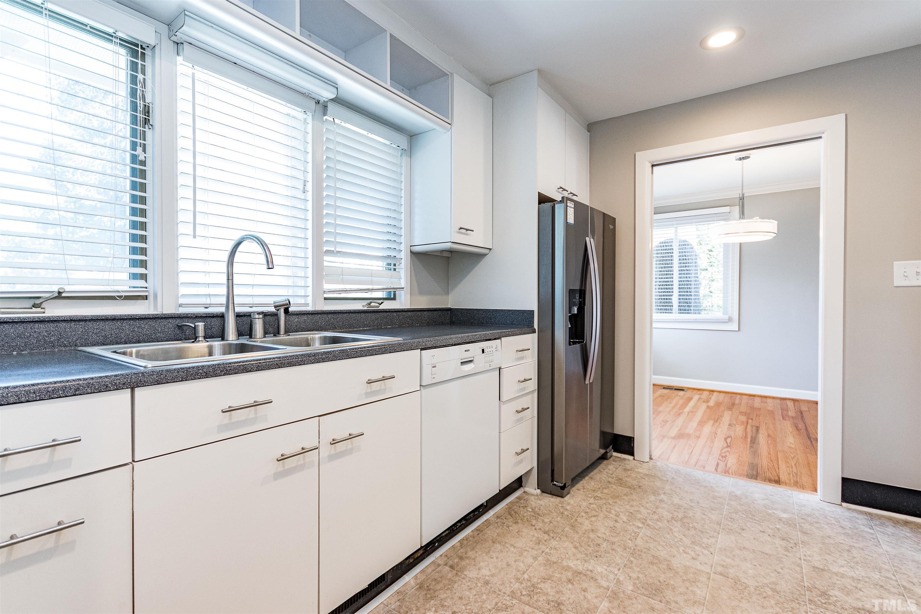 3412 Bradley Place Raleigh, NC 27607 - Photo 16 of 28 a kitchen with granite countertop a refrigerator and a sink