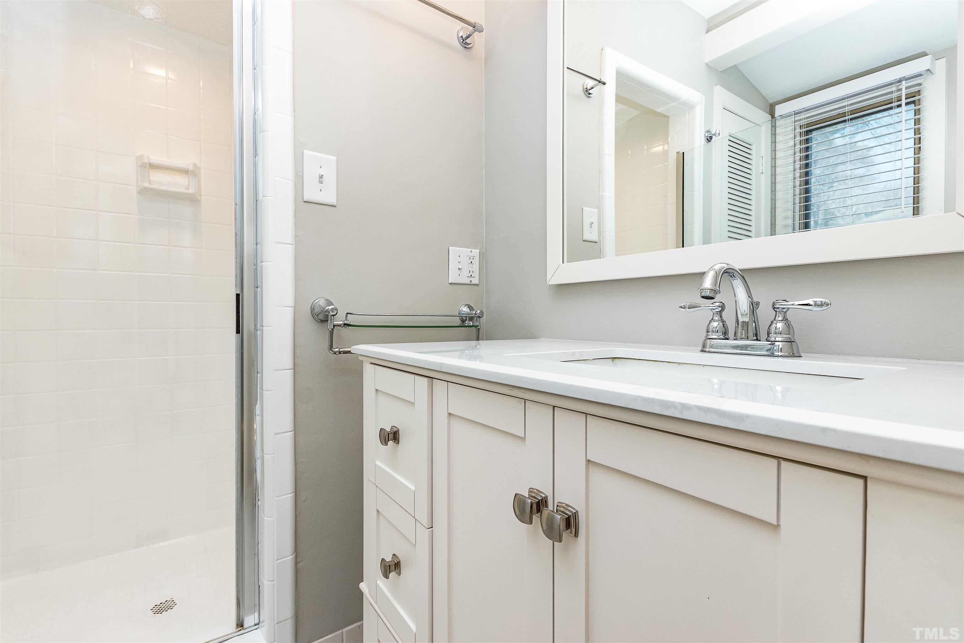 3412 Bradley Place Raleigh, NC 27607 - Photo 19 of 28 a bathroom with a sink and a mirror