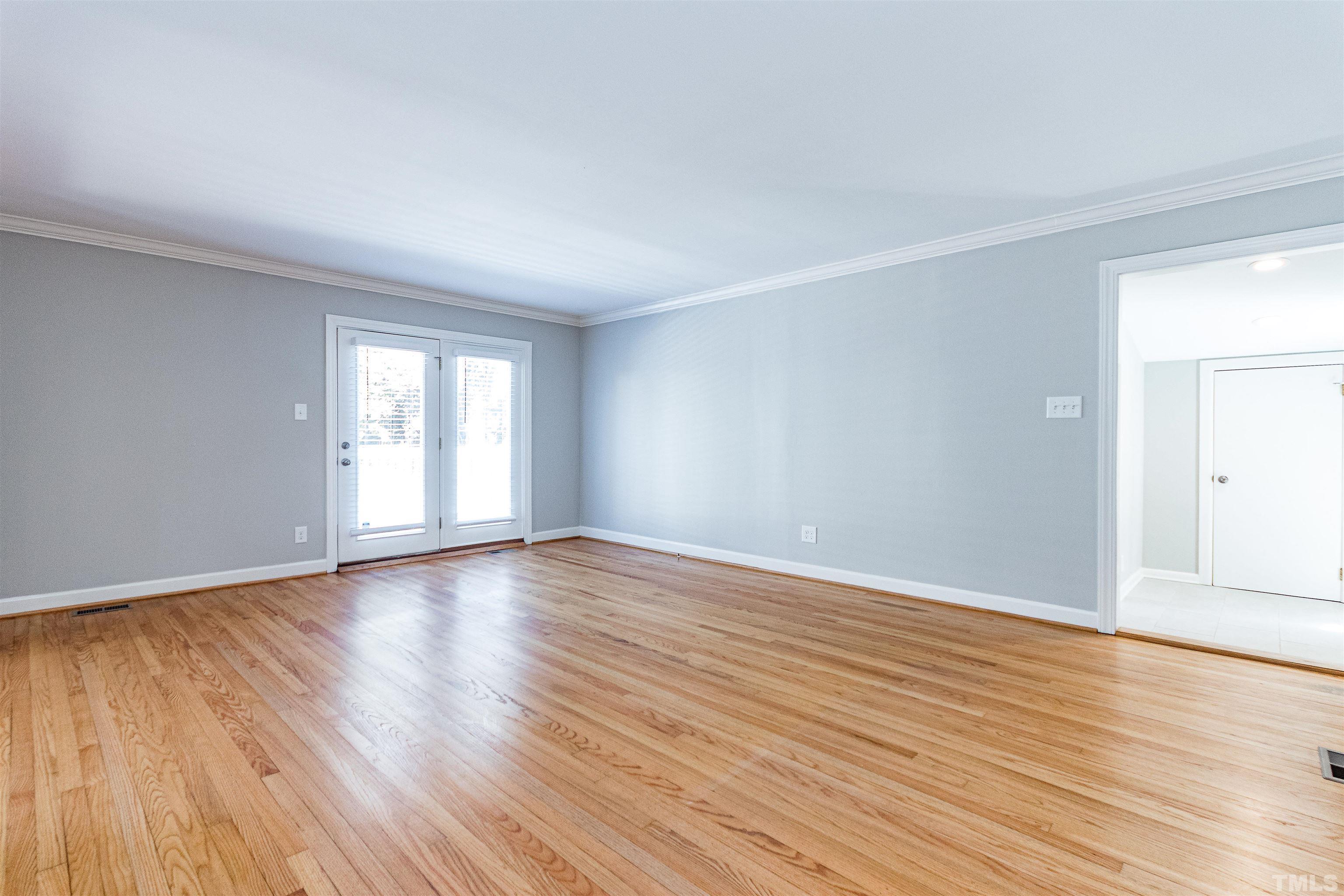 3412 Bradley Place Raleigh, NC 27607 - Photo 8 of 28 a view of an empty room with wooden floor and window