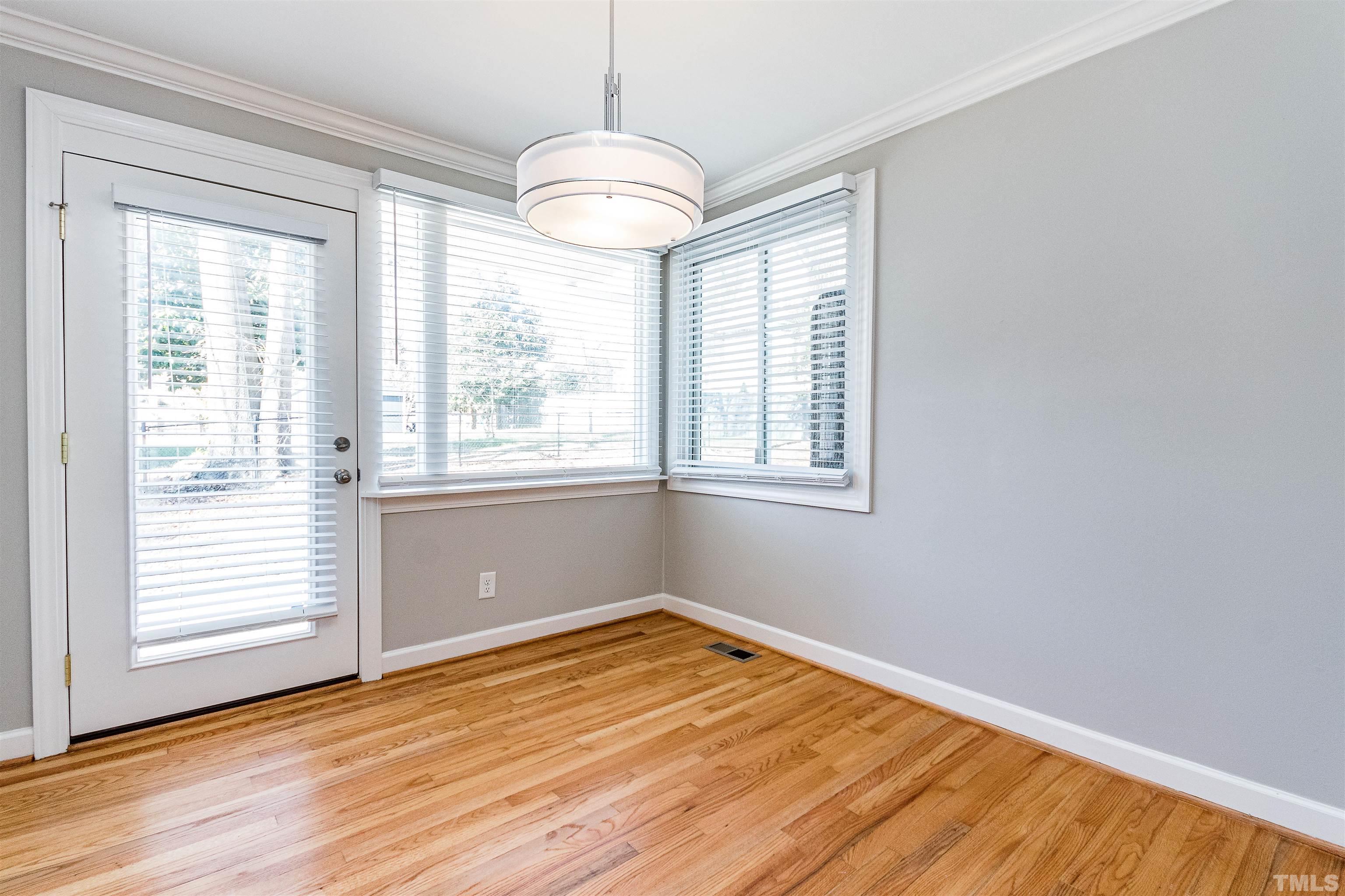 3412 Bradley Place Raleigh, NC 27607 - Photo 9 of 28 a view of empty room with wooden floor and fan